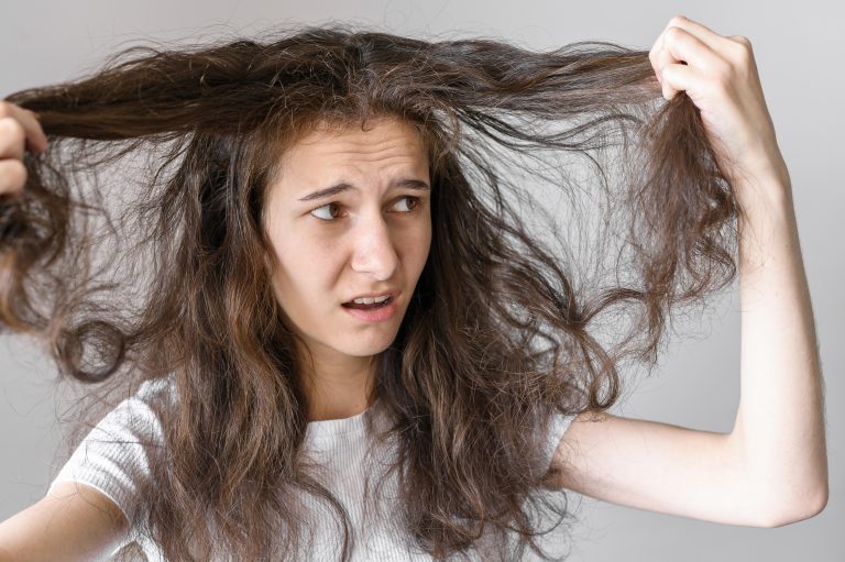 woman-worried-about-tangled-hair-768x511